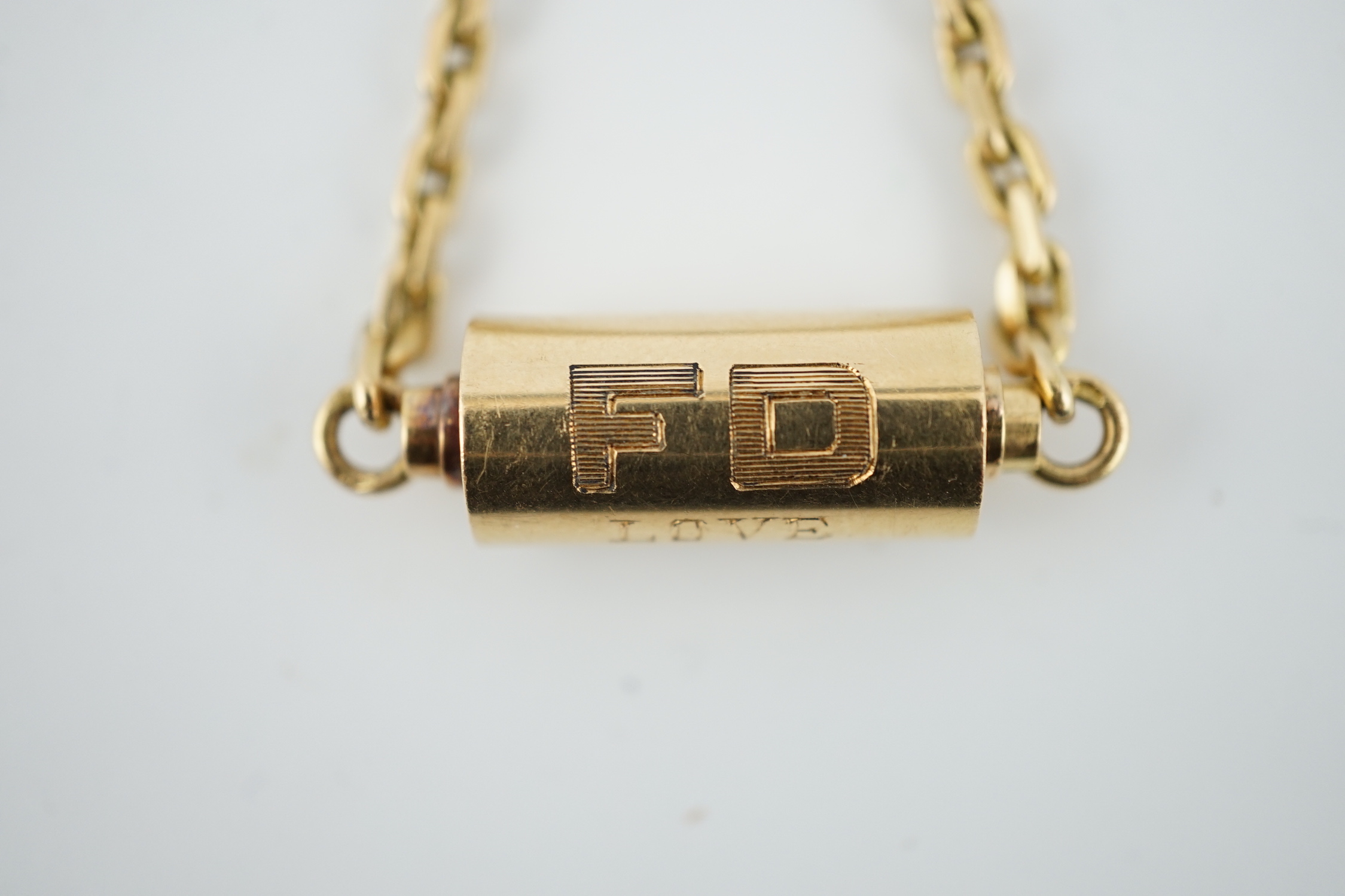 A mid to late 20th century Cartier 18ct gold barrel shaped key ring, with suspension chain